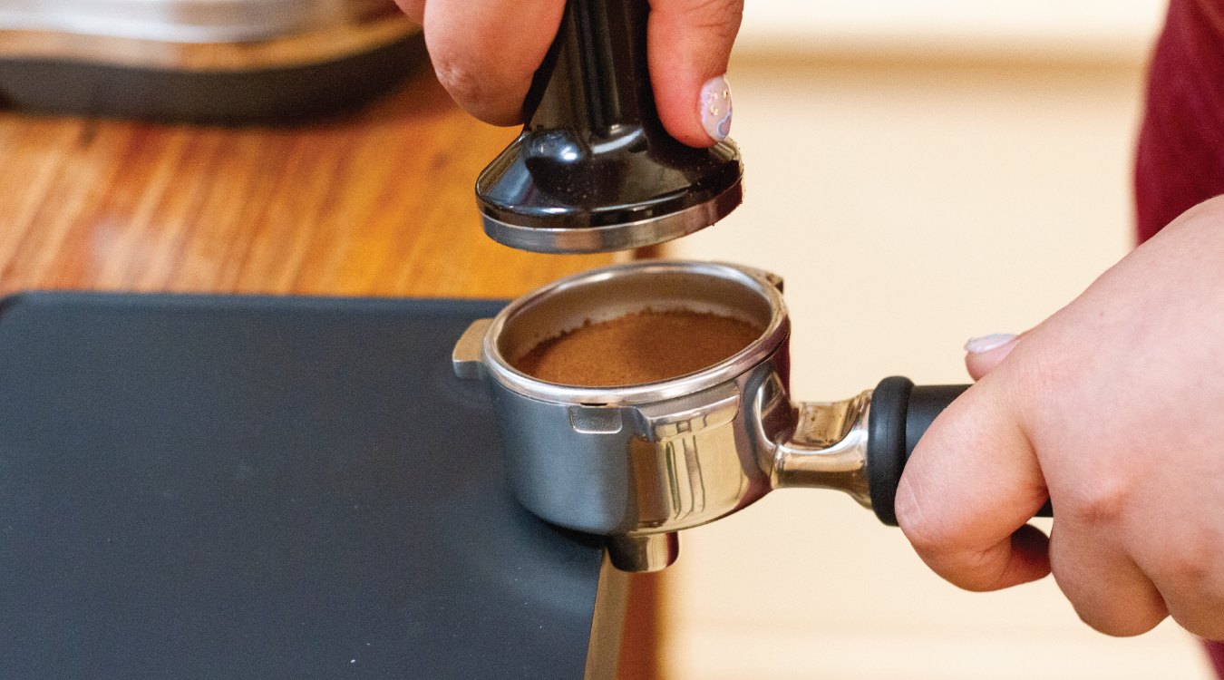 Tamping puck of coffee from Rumble Coffee in Kensington