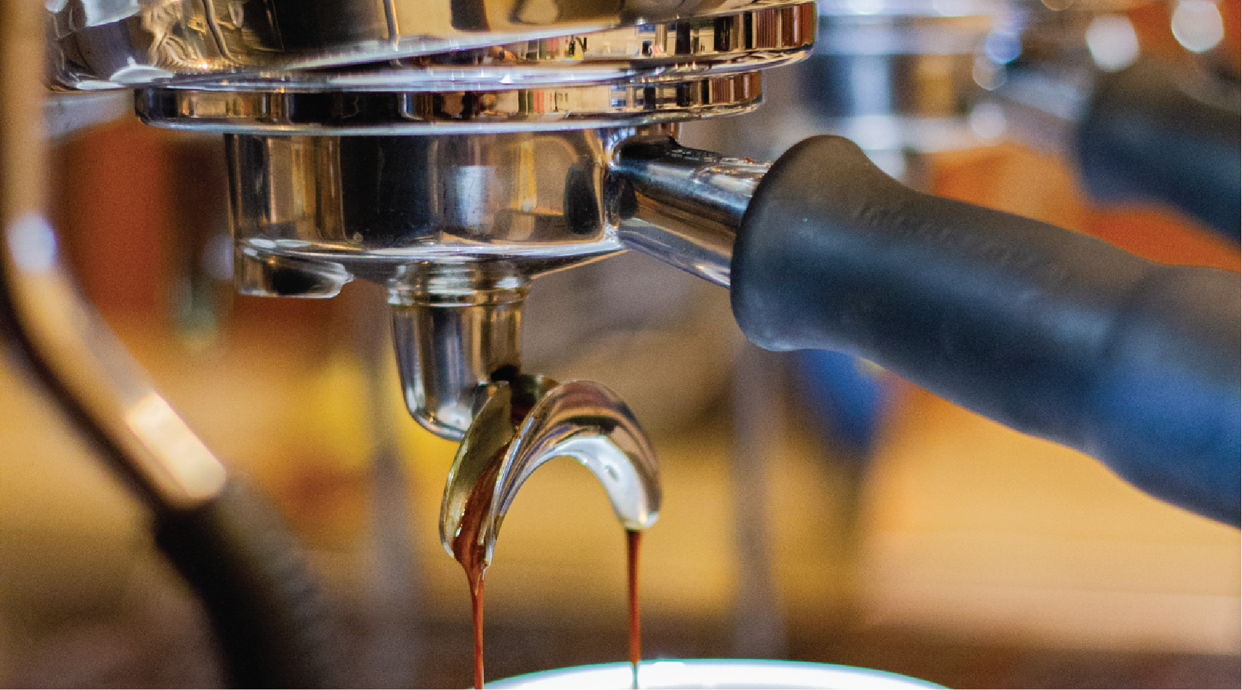 Coffee extracting and pouring out from a commercial coffee machine at Rumble Coffee Roasters