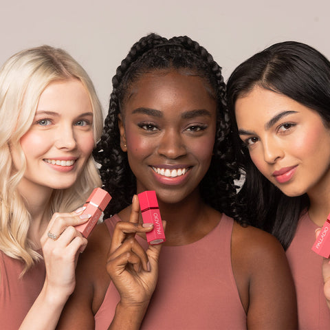 Group of 3 models (1 fair skin, 1 medium skin, 1 rich skin) wearing Palladio's newest Liquid Blush for cheeks and lips.