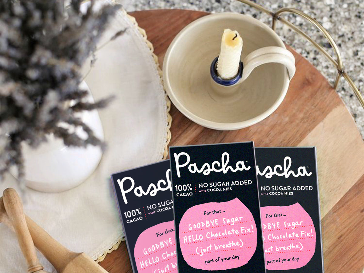 Pascha 100% Cacao Bars on a table with lavender and a candle