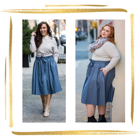 Woman on left wears light grey sweater layered over cream blouse, paired with knee length blue-grey skirt with 3 pleats and paperbag pleating at waistline and matching belt tied in a bow. Woman on right wears same skirt paired with black and white striped shirt with large chunky knit pastel scarf