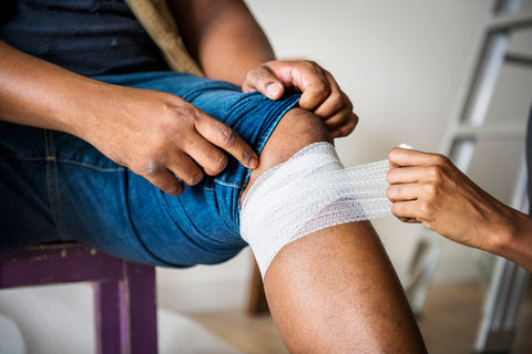 Image source: https://www.pexels.com/photo/person-putting-bandages-on-another-person-s-knee-1385747/
