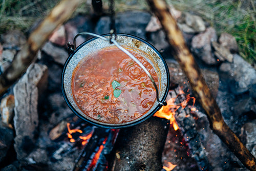 Chili cooking over a campfire