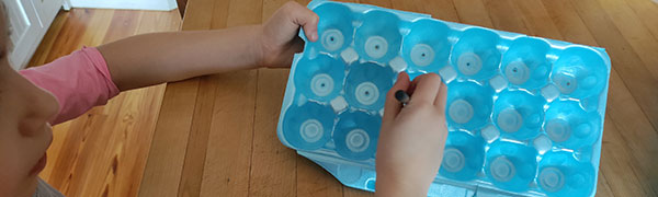 poking holes in the bottom of the egg carton