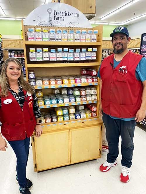 Westlake Ace employees standing in front of Fredericksburg Farms products