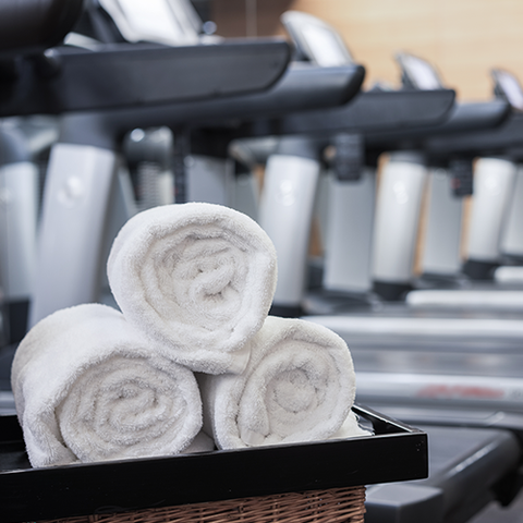 Three clean white towels in a gym