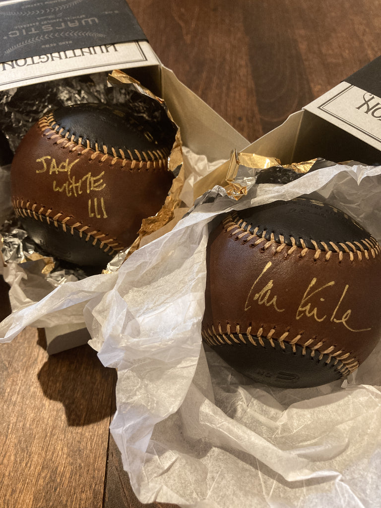 Close up of the autographed baseballs spilling out of their boxes.