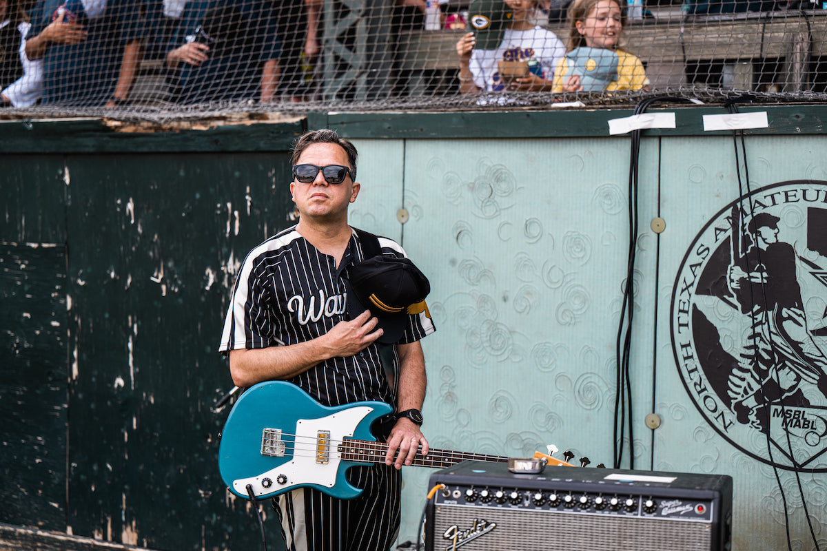 Bass Player Dominic Davis holds his hat over his heart during the National Anthem