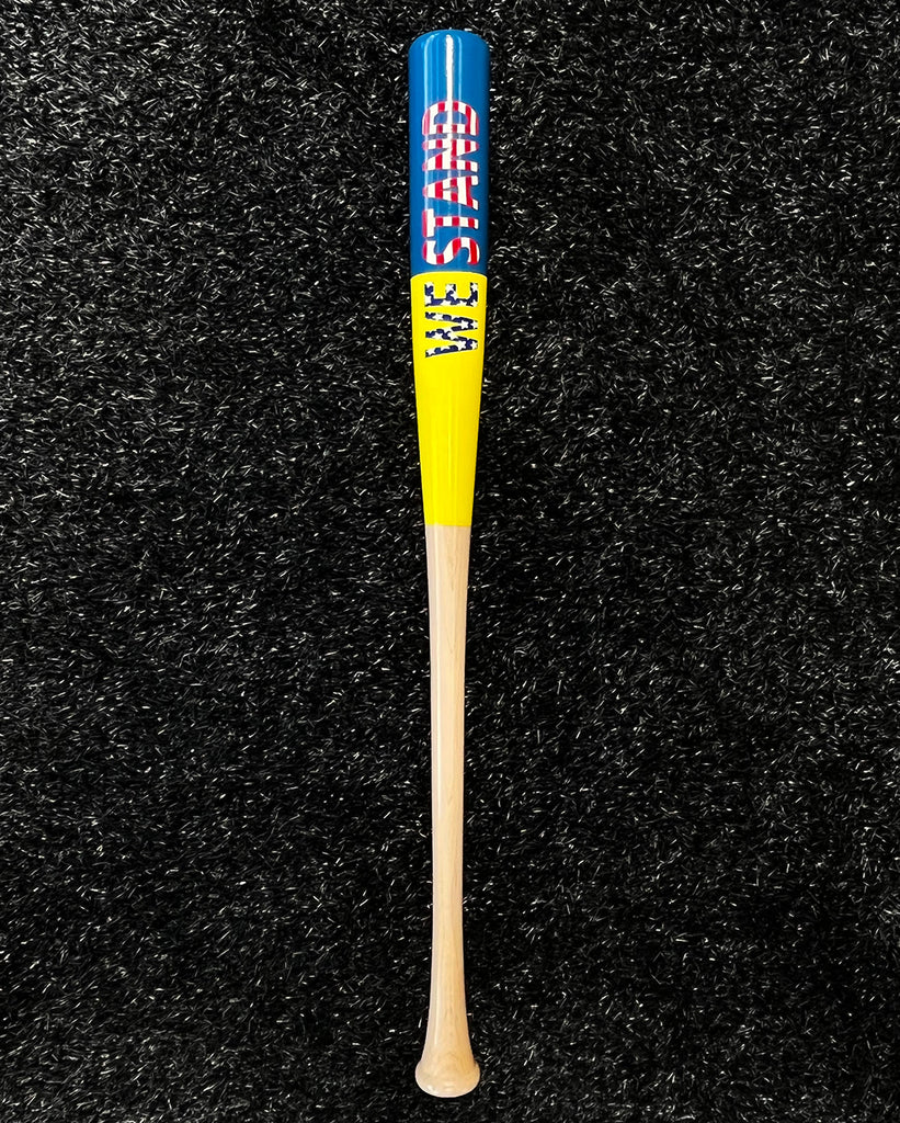 View of the back of the "We Stand" Bat, with its sun and royal blue barrel and "We Stand" US Flag effect decal.