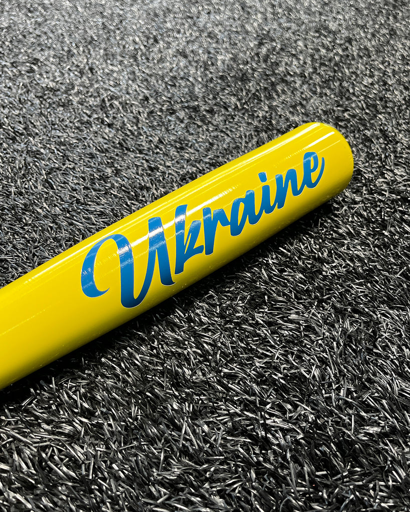 Close up of the royal blue "Ukraine" painted in script on the yellow barrel.