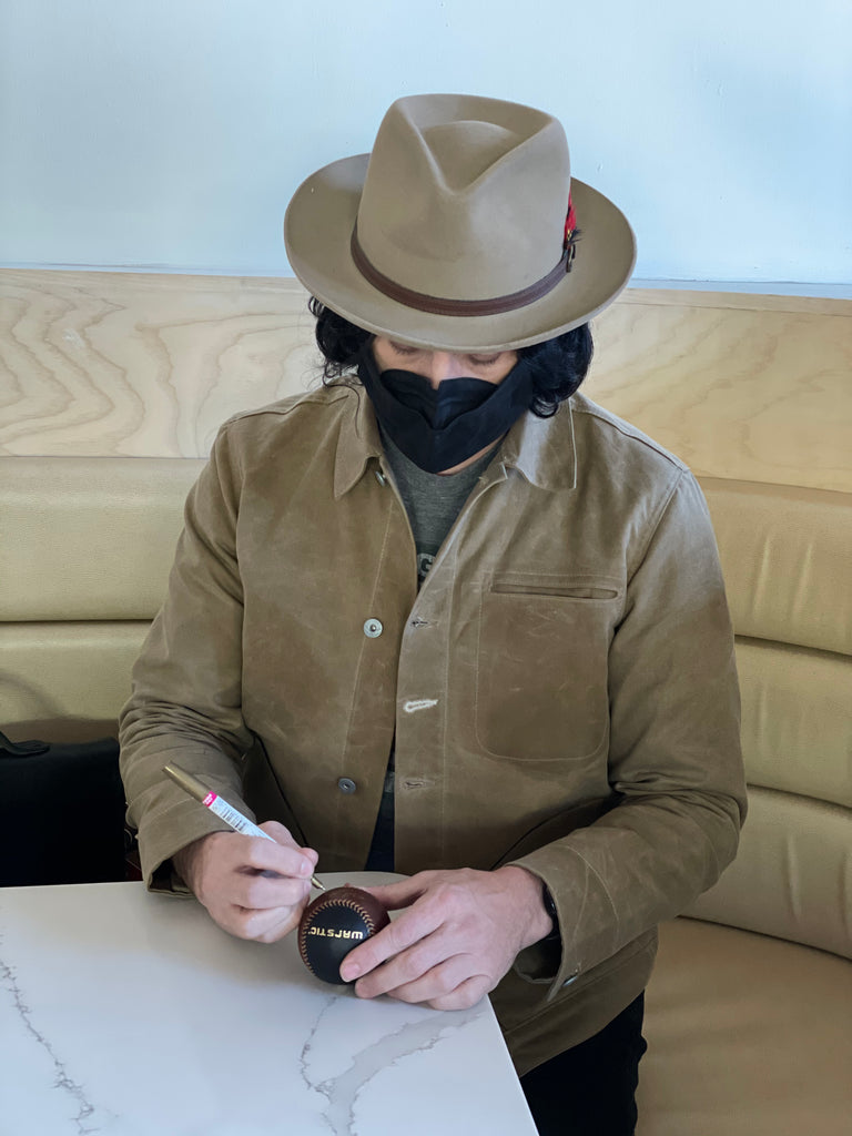 Jack White Autographing a baseball.