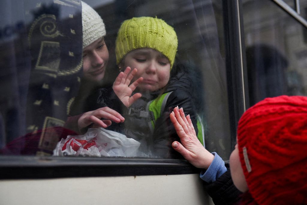 Young Ukrainian girls say goodbye to their mother as the go to safety.