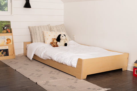 a floor bed with a stuffed animal