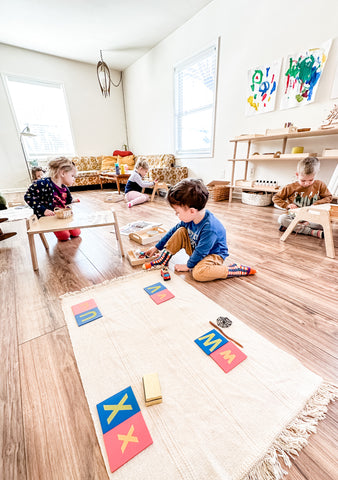 Children work on Montessori tasks on Chowki tables and floor mats