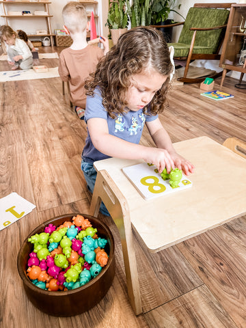 A small girl work at a Chowki floor table