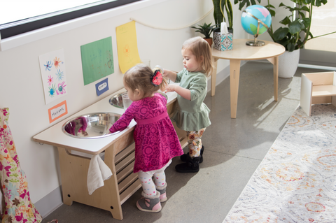 Children at a dish washing station