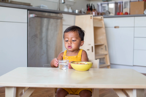 Child drinking from a glass cup