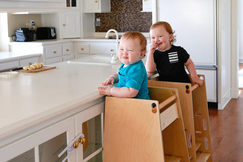 Children in a kitchen toddler tower