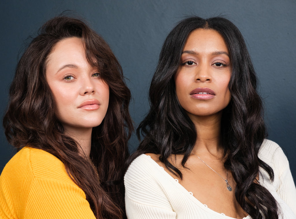 Image of two women wearing curled Frontrow clip-in hair extensions