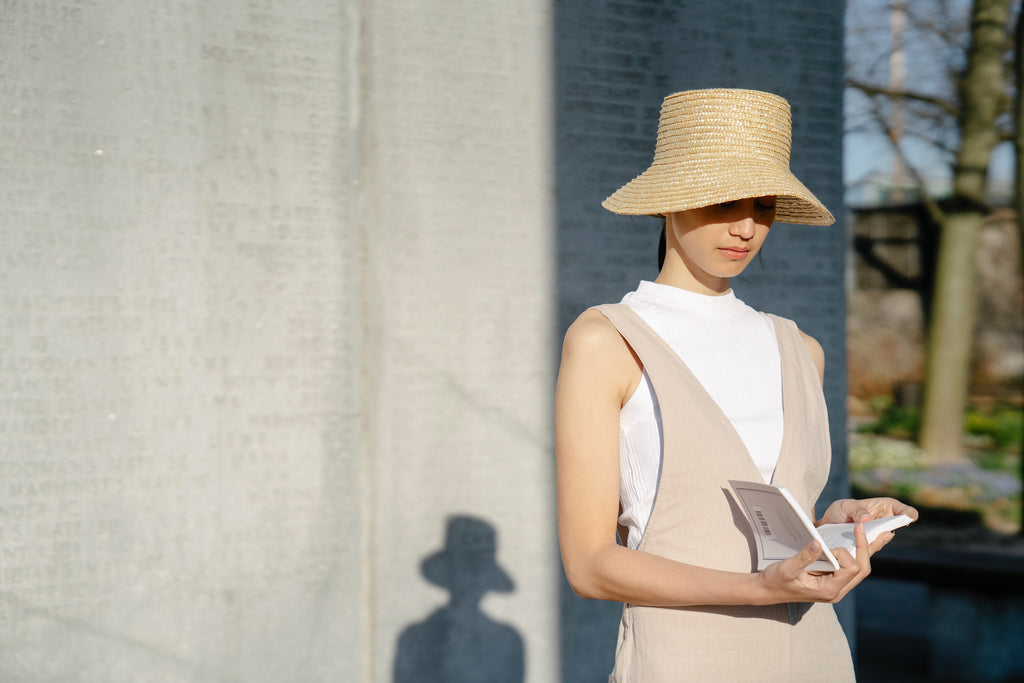Image of woman wearing a hat to protect her hair from sun damage