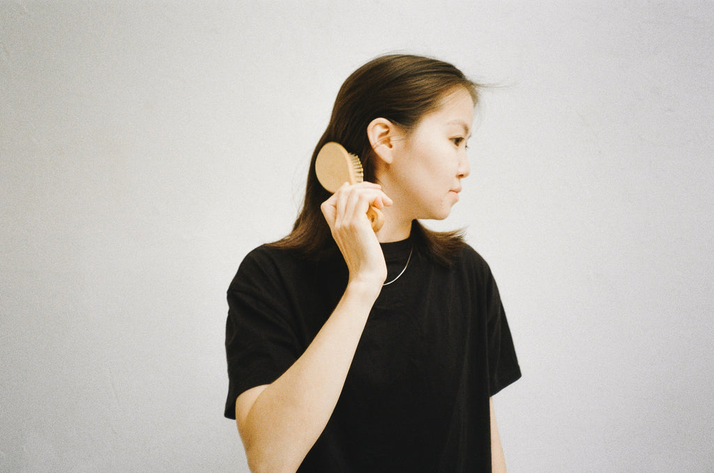 Image of woman brushing her hair