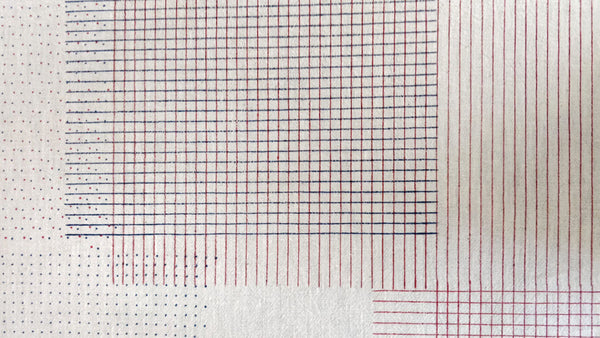 brass block hand printed swatches of straight lines, dots and checks in red and blue colour
