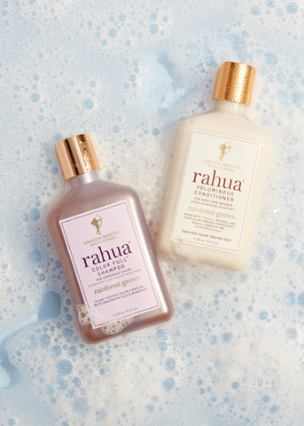 Rahua color full shampoo and voluminous conditioner on the floor with foam