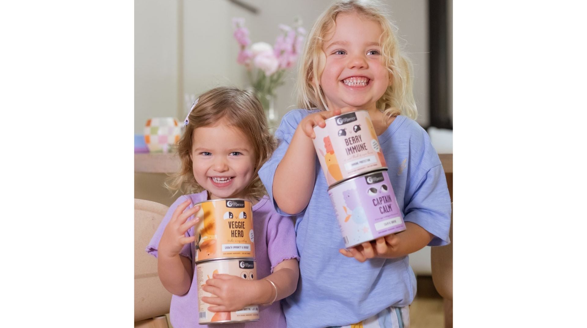 Two children holding Nutra Organics Products 