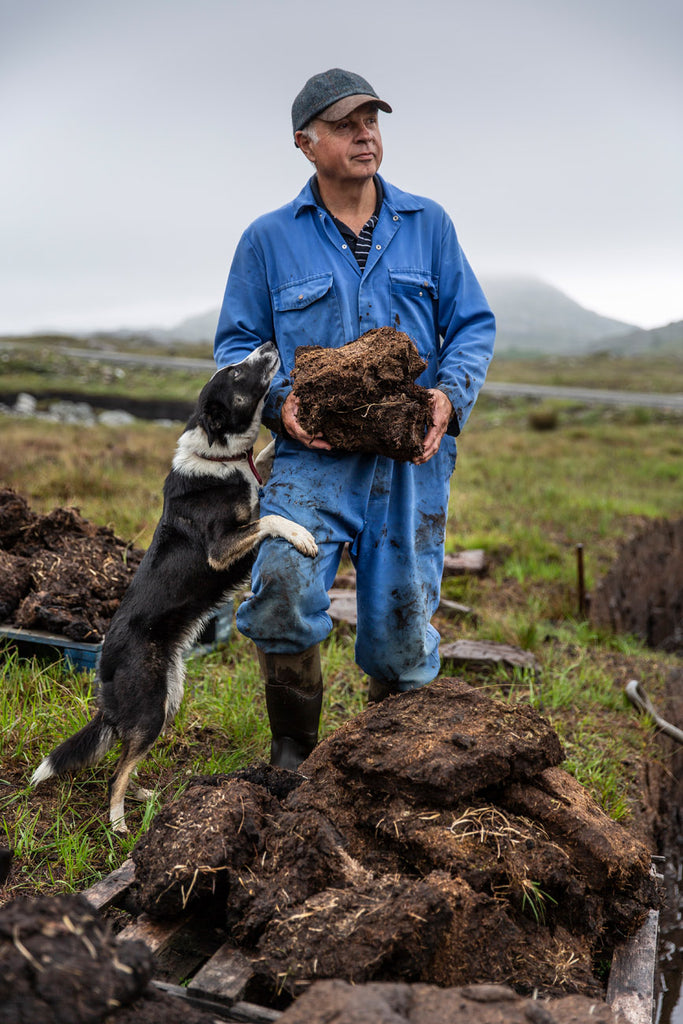 Bill Cross (and friend) at the peats, soon to be fully dried and brought home.