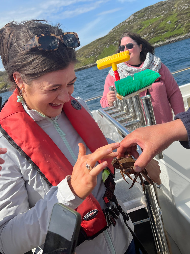 Iona gets hands-on with a Velvet crab.