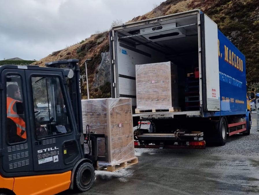 Pallets of Isle of Harris Gin are readied for the road in Tarbert...