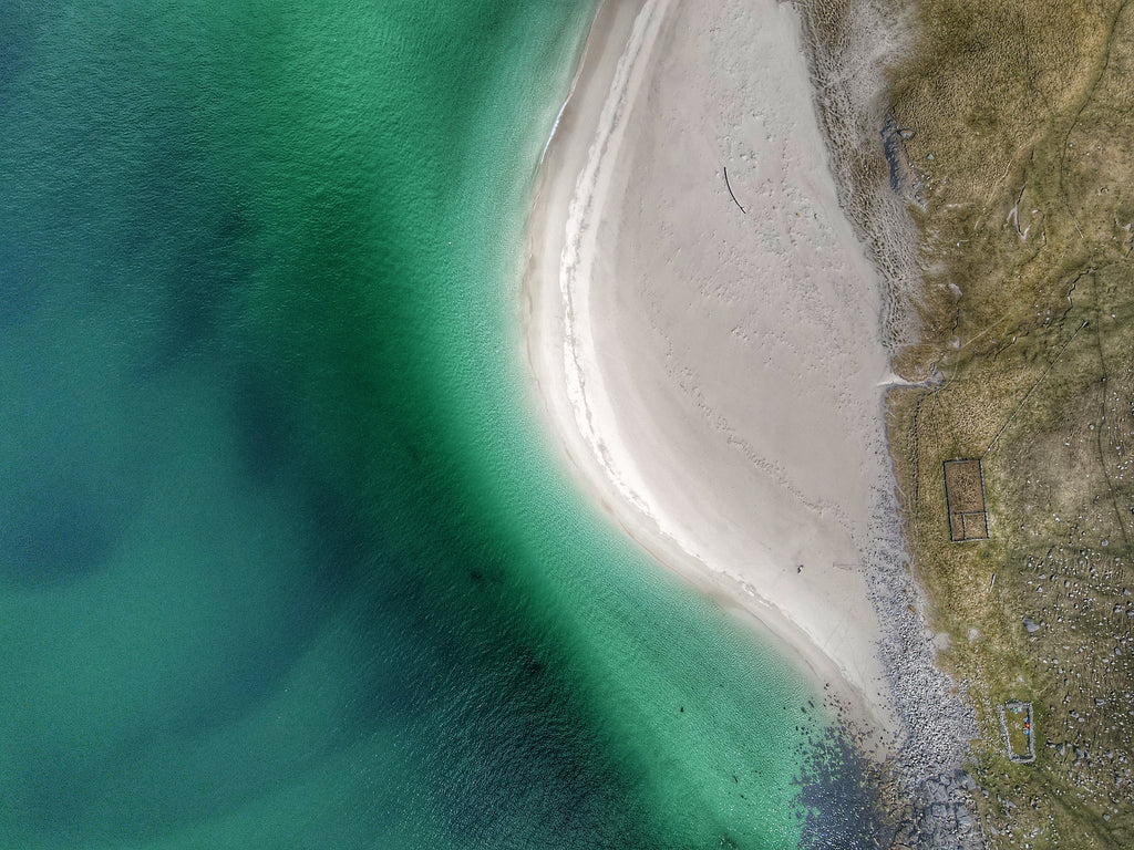Green seas and sandbanks meet at the bulge of a beach. Image © Iain Angus Macleod