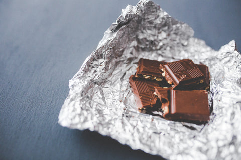 Chocolate bar with nuts in a foil wrapper