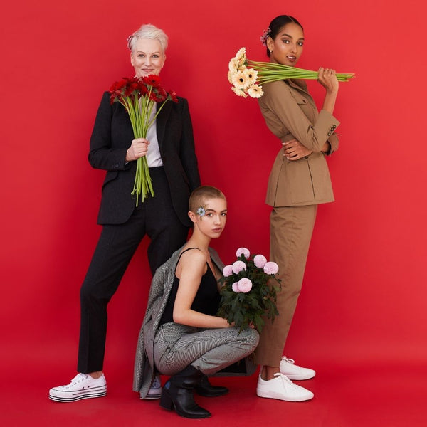 three women holding flowers