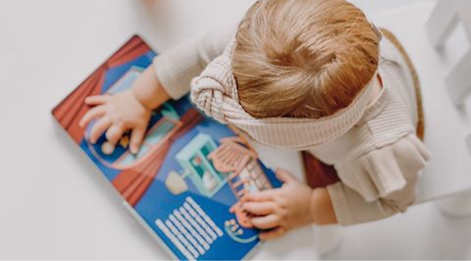 Kid playing with Mizzie Sound Book