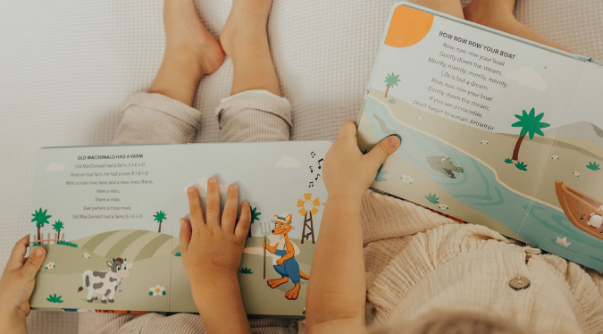 Babies reading Mizzie The Kangaroo musical book