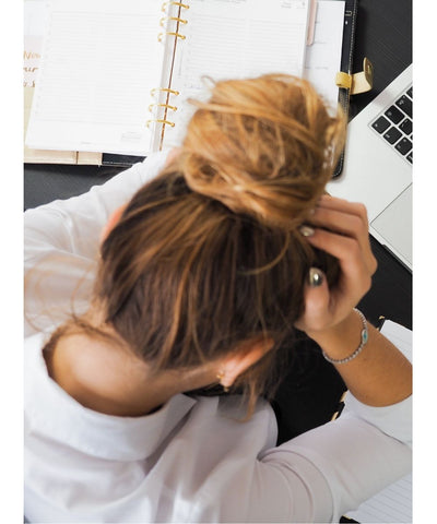 Woman Stressed looking Over a laptop