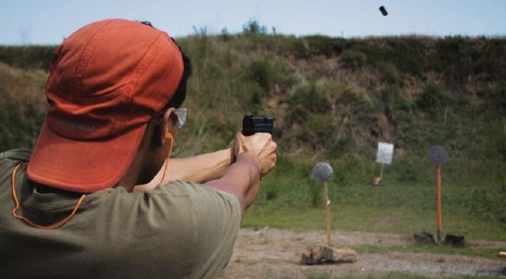 A man practicing shooting in a shooting range