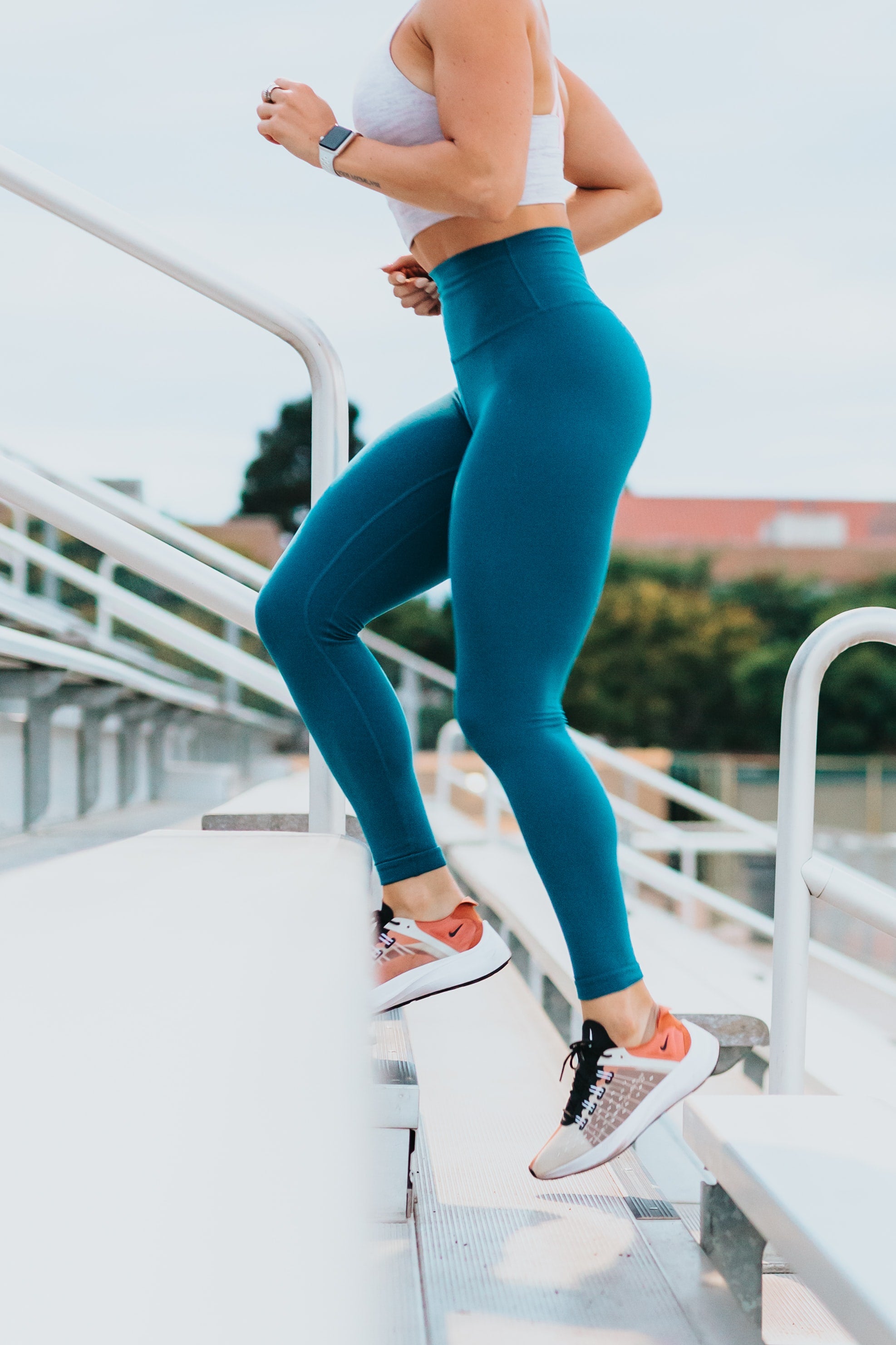 fit woman running up stairs