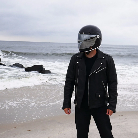 Man in Leather Jacket and Helmet at Beach