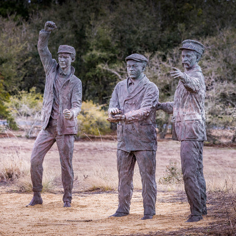 3 sculptures of men in uniform from the early 1900's