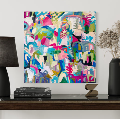 pink colorful abstract art hung on wall with mix of contemporary stone home furnishings
