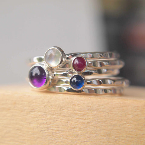 Stacking Ring Set in Sterling Silver with purple, white, red and blue gemstones with a hammer texture band. Handmade by maram jewellery in Scotland