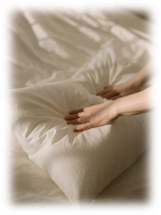hand touching the soft and comfortable pillow with white pillow case
