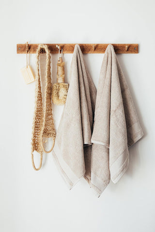 Wooden rack with towels and bath accessories.
