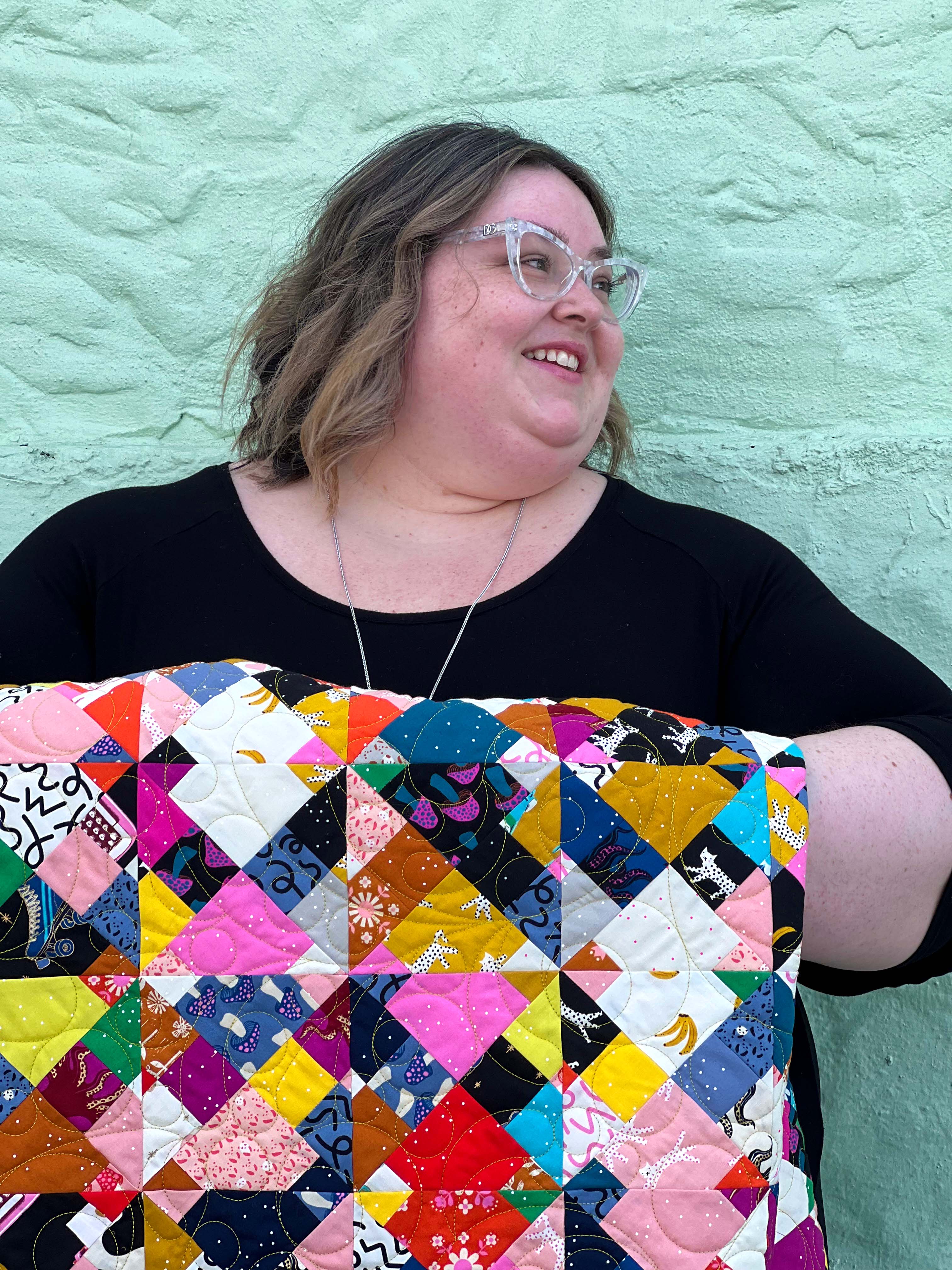 Me, Kelly Renay holding the Utter Chaos quilt