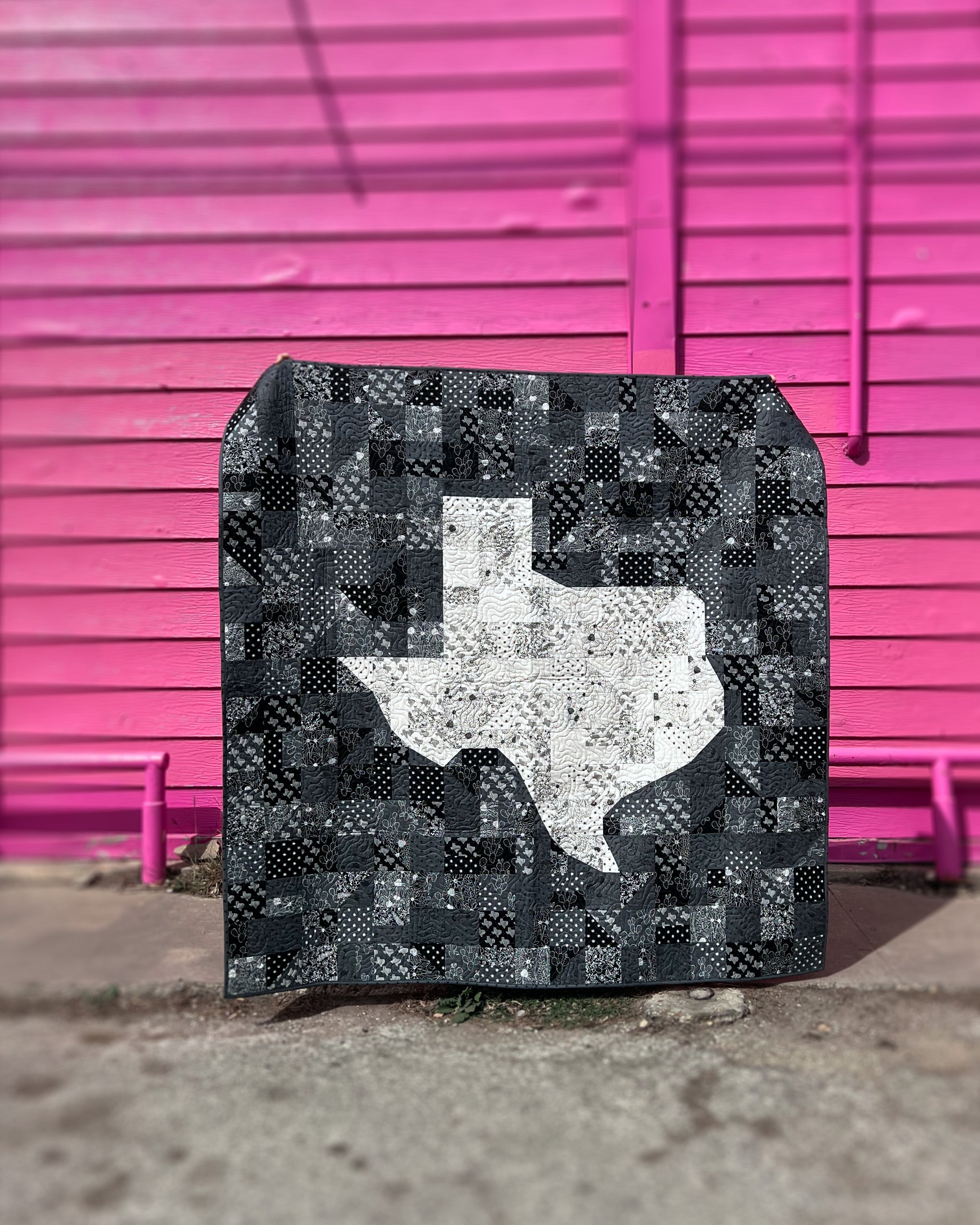 Howdy Texas Quilt against pink wall