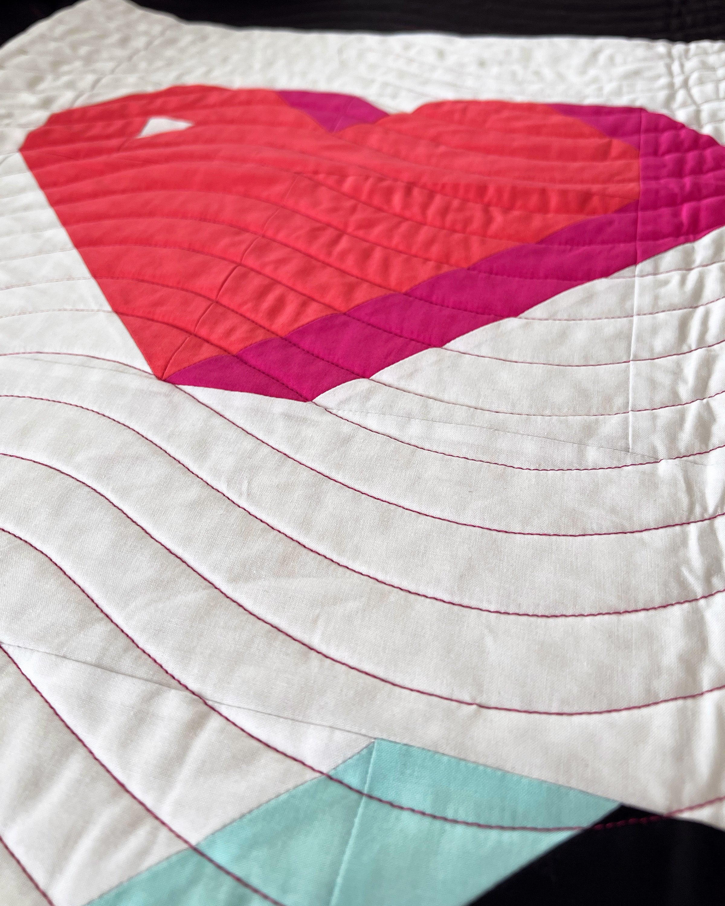 close up on thread color and long-arm quilting on the Send with Love quilt