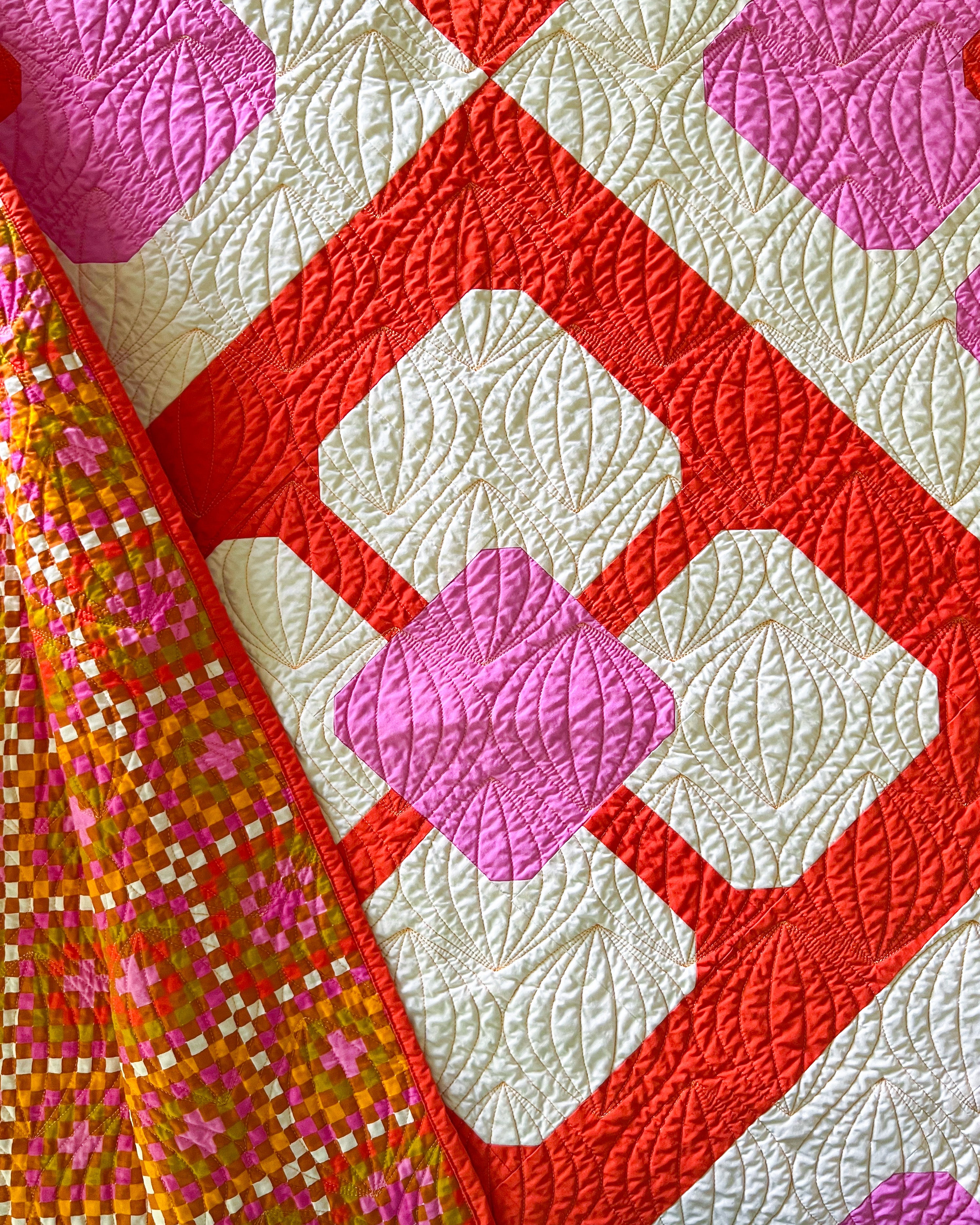 Smashing Petals Quilt, the retro-mod version, made with Art Gallery Fabric Pure Solids, showcasing a flipped corner of the backing fabric by Ruby Star Society