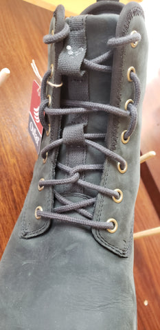 a boot laced with two alternative lacing methods for display